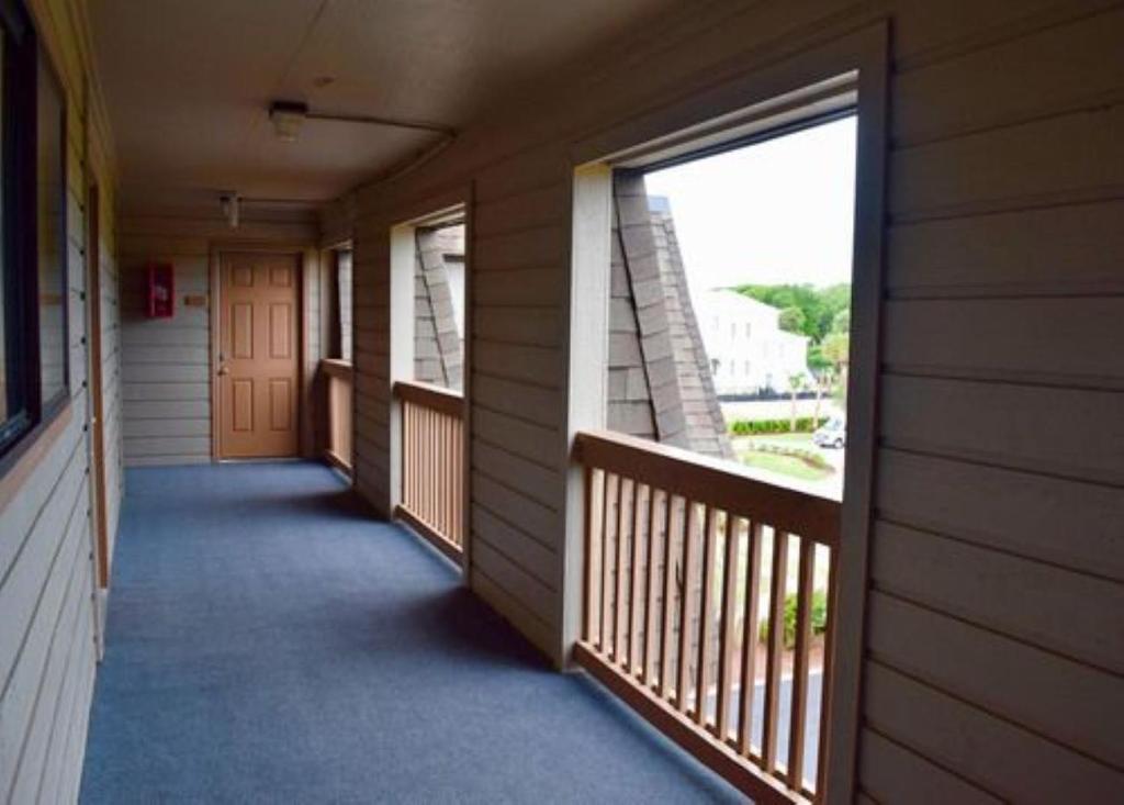 an empty hallway of a house with a balcony at Ocean Forest Colony by Capital Vacations in Myrtle Beach