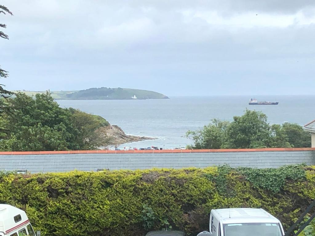 two white trucks parked in front of a view of the ocean at Flat 7, Tremorvah Court in Falmouth