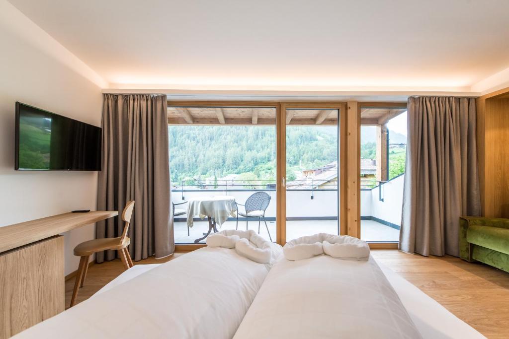 Postel nebo postele na pokoji v ubytování Hotel Taufers