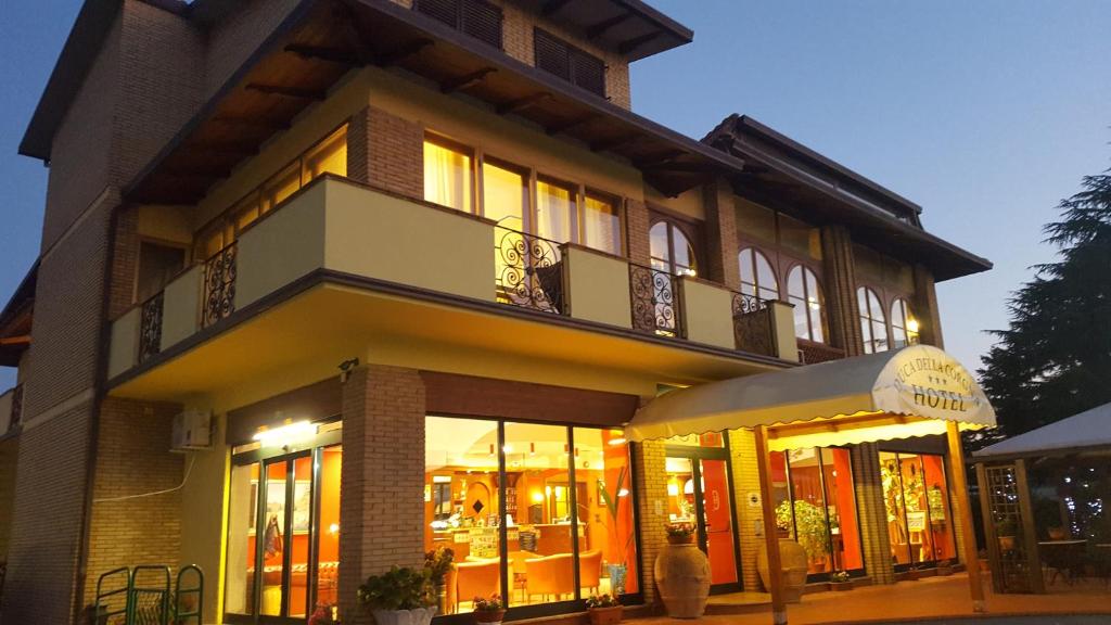 a building with a store front with lights in it at Hotel Duca Della Corgna in Castiglione del Lago