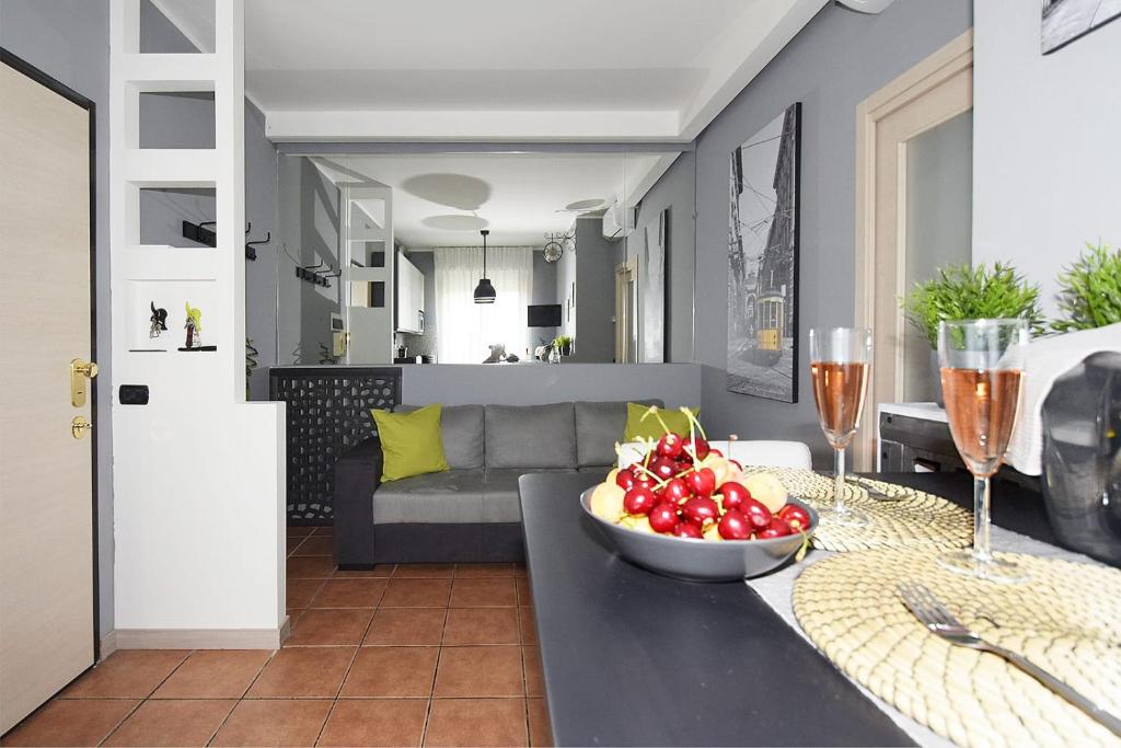 una cucina e un soggiorno con un cesto di frutta su un tavolo di Co&Mo bilocale adiacente Duomo a Milano