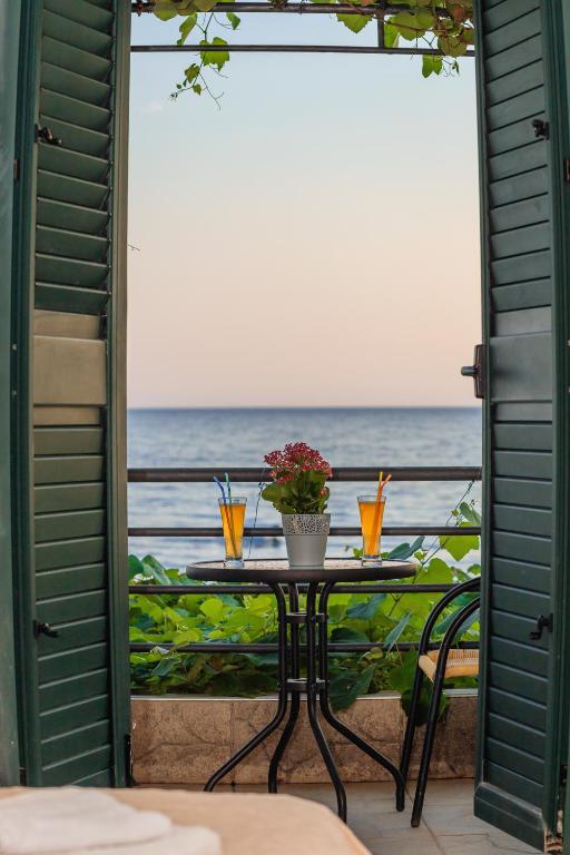 a table with a view of the ocean from a patio at Hotel Savojo in Petrovac na Moru