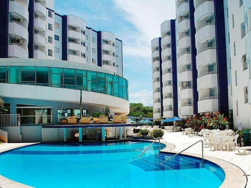 a large building with a swimming pool in front of it at ÁGUAS da SERRA - RIO QUENTE in Rio Quente