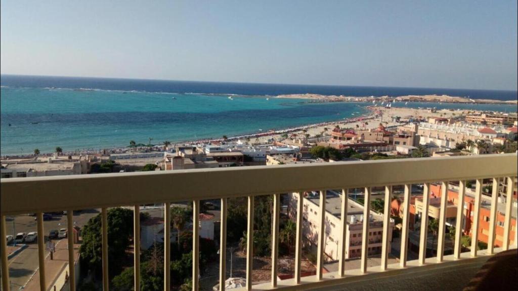 a view of the ocean from a balcony of a building at Al-Madina Tower Apartments in Marsa Matruh