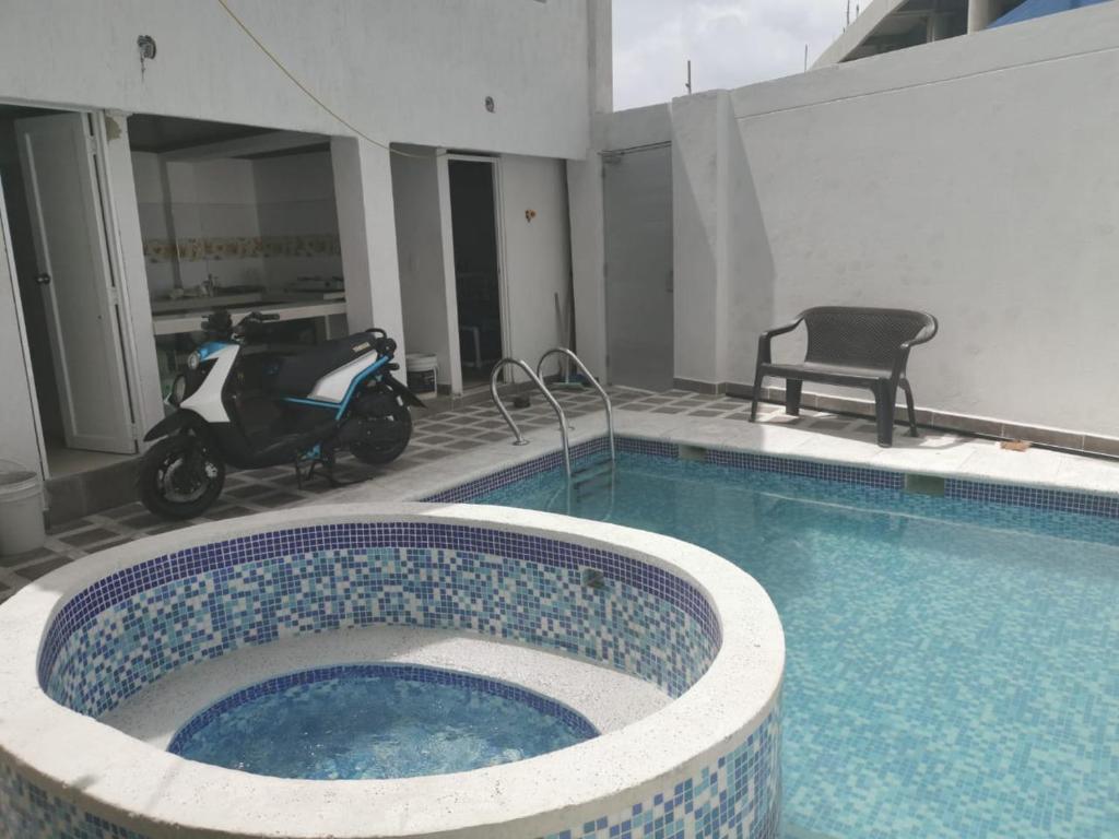 a swimming pool with a motor scooter in a building at Bull Shark in San Andrés