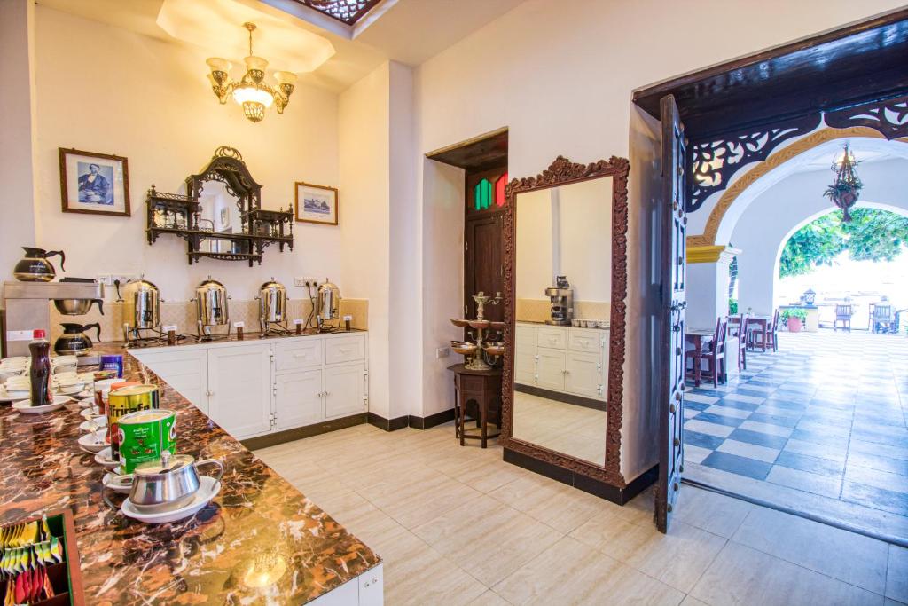 a large room with a mirror and a counter at Tembo House Hotel in Zanzibar City