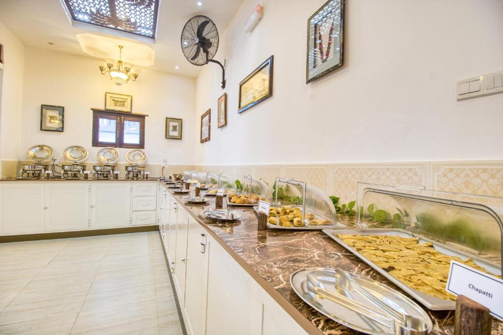 a large kitchen with food on a counter at Tembo House Hotel in Zanzibar City