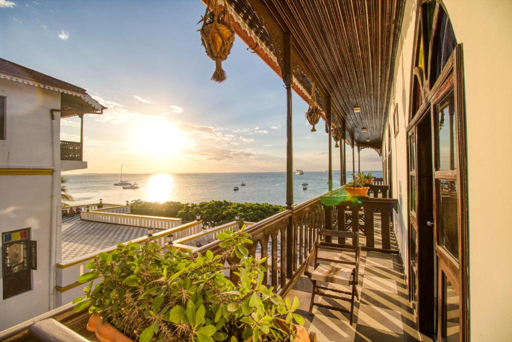 a balcony of a house with a view of the ocean at Tembo House Hotel in Zanzibar City
