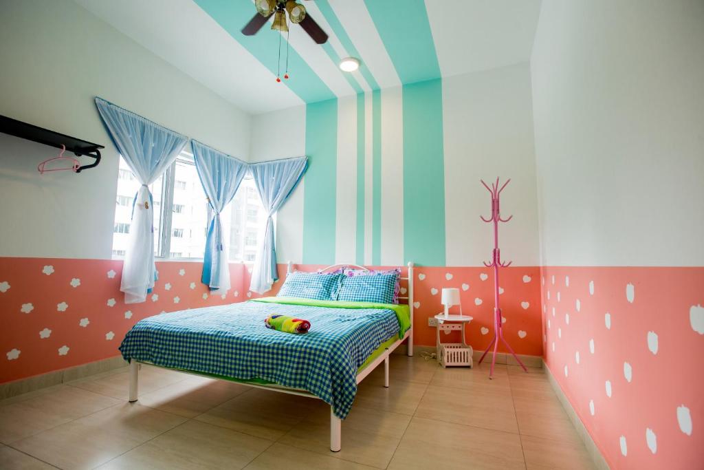 a bedroom with a bed with a toy on it at ICOLOR HOME & STAY CH1 in Tanah Rata