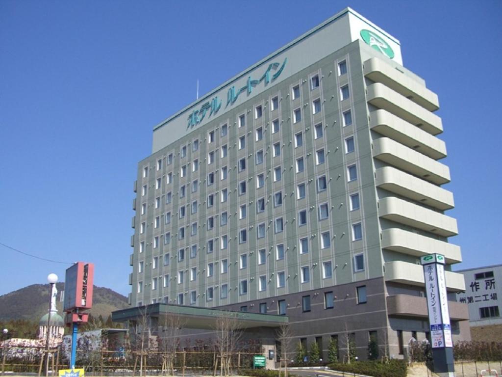 a building with a sign on the side of it at Hotel Route-Inn Wakamiya Inter in Miyawaka