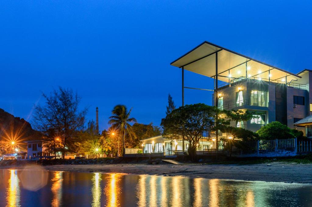 a building on the beach at night at Aownoi Bay Resort in Prachuap Khiri Khan