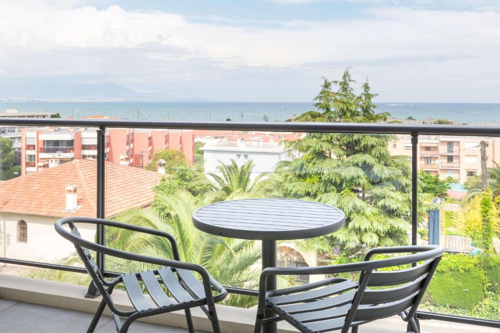 a table and chairs on a balcony with a view of the ocean at Best Western Plus Antibes Riviera in Antibes