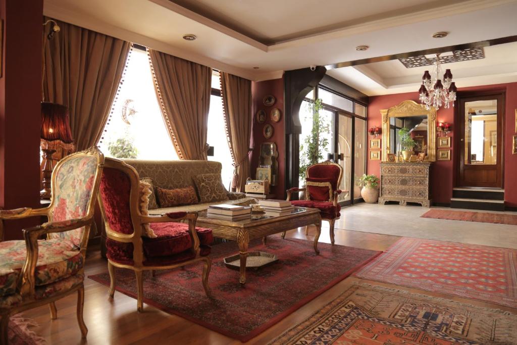 
a living room filled with furniture and a large window at Gondola Hotel & Suites in Amman
