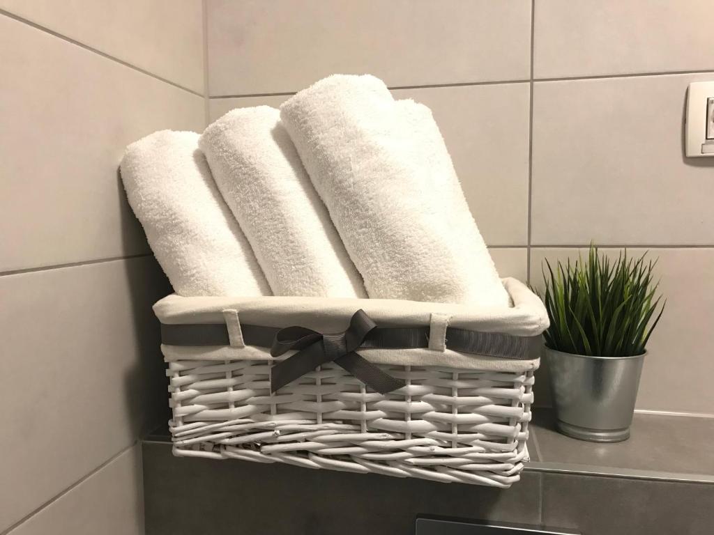 a group of towels in a basket in a bathroom at Ocean Apartment in Zagreb