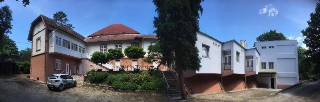 a house with a car parked in front of it at Kiss Villa in Balatonföldvár