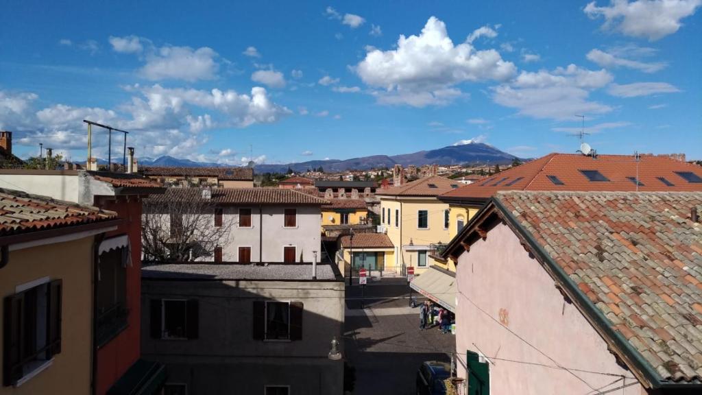 a view of a city with buildings and a mountain at Casa Beccherie in Lazise