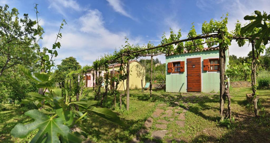 a house in the middle of a field with trees at Glamping & Camping Green Istria in Marezige