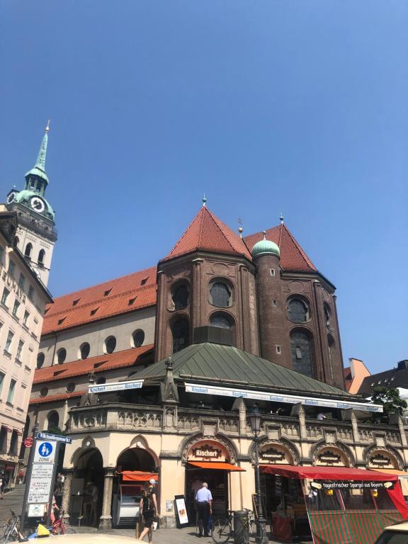 a large building with a clock tower on a street at Luxurious 2 Bedroom Apartment Old City in Munich