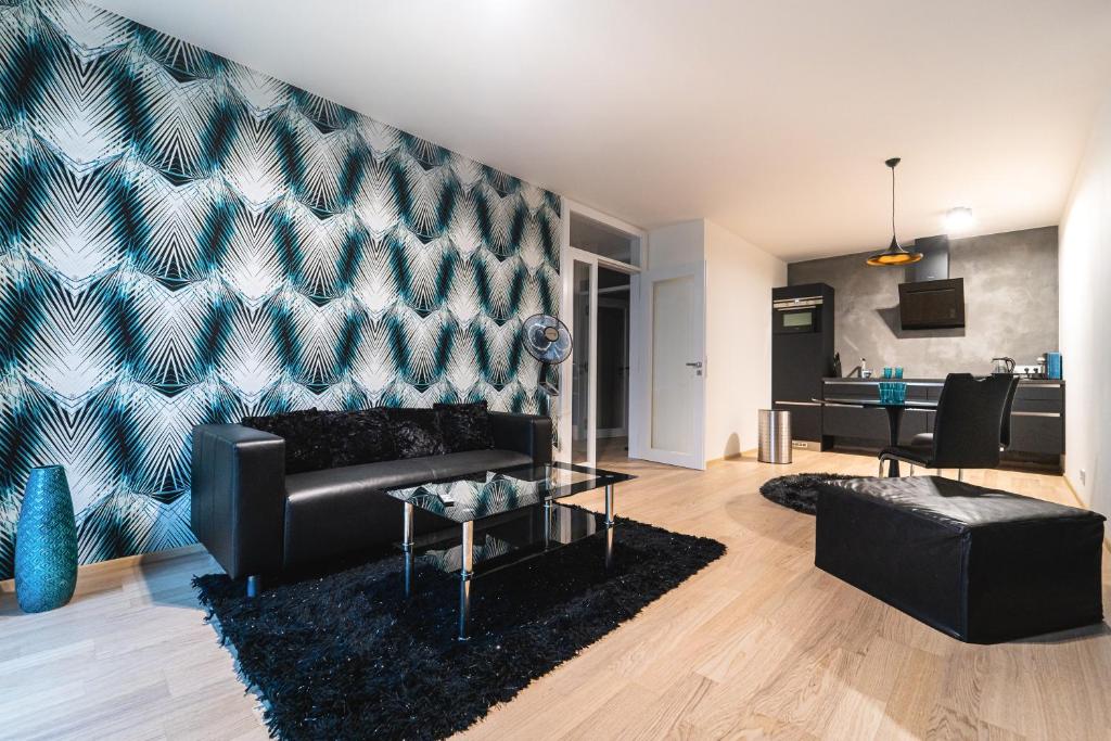 a living room with a couch and a table at In Apartments in Brno