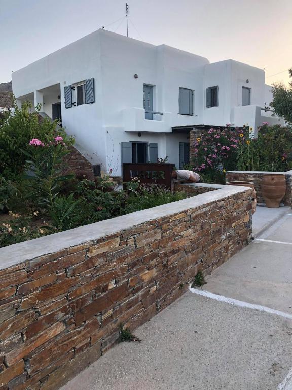a brick retaining wall in front of a house at Nefeli in Livadi