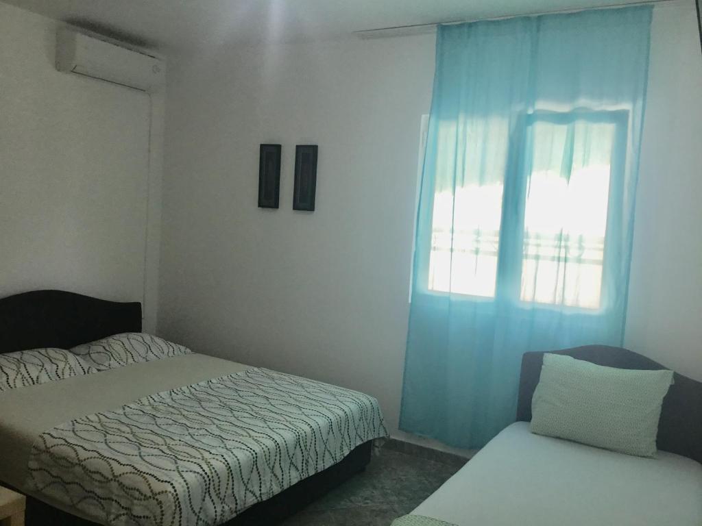 Postel nebo postele na pokoji v ubytování DK Apartmani