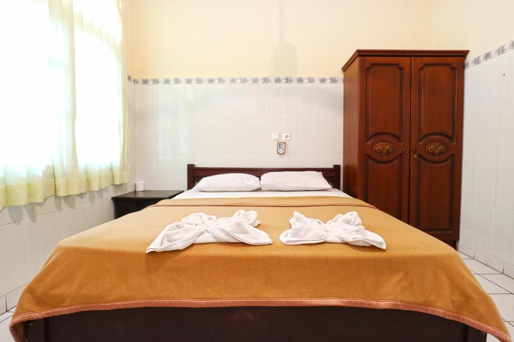 Postel nebo postele na pokoji v ubytování Gora Beach Inn