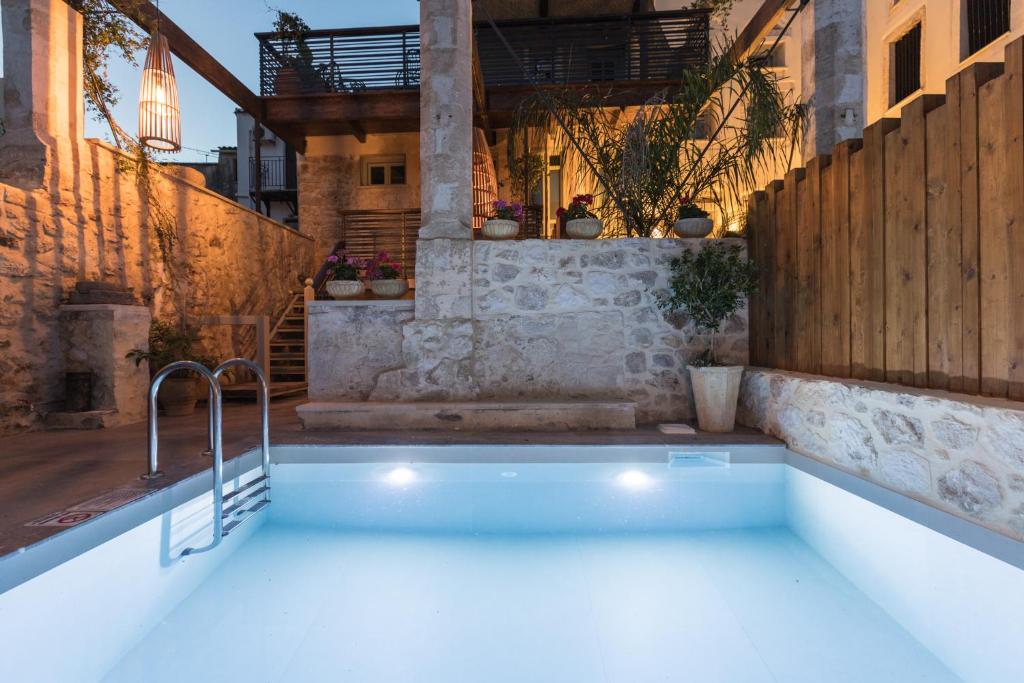 a swimming pool in the middle of a house at Casa Vitae Villas in Rethymno