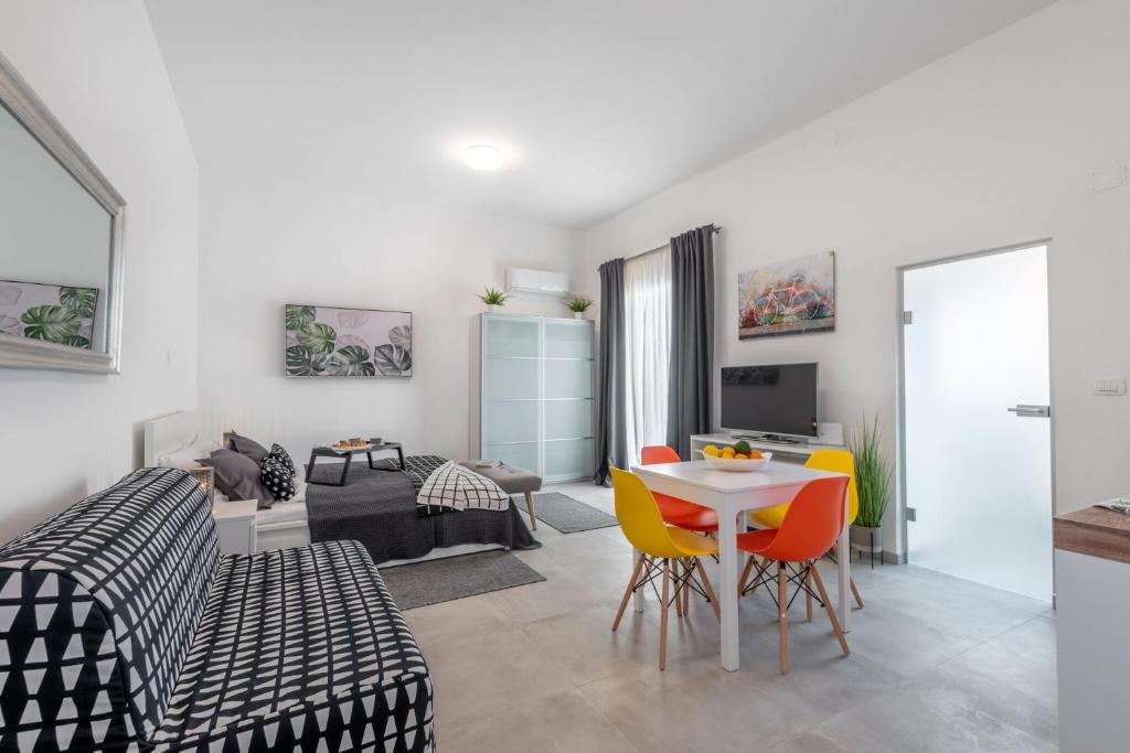 a living room with a table and chairs at Apartment Tara & Ana in Pula
