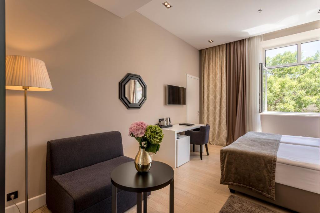 Posteľ alebo postele v izbe v ubytovaní Cornaro Hotel