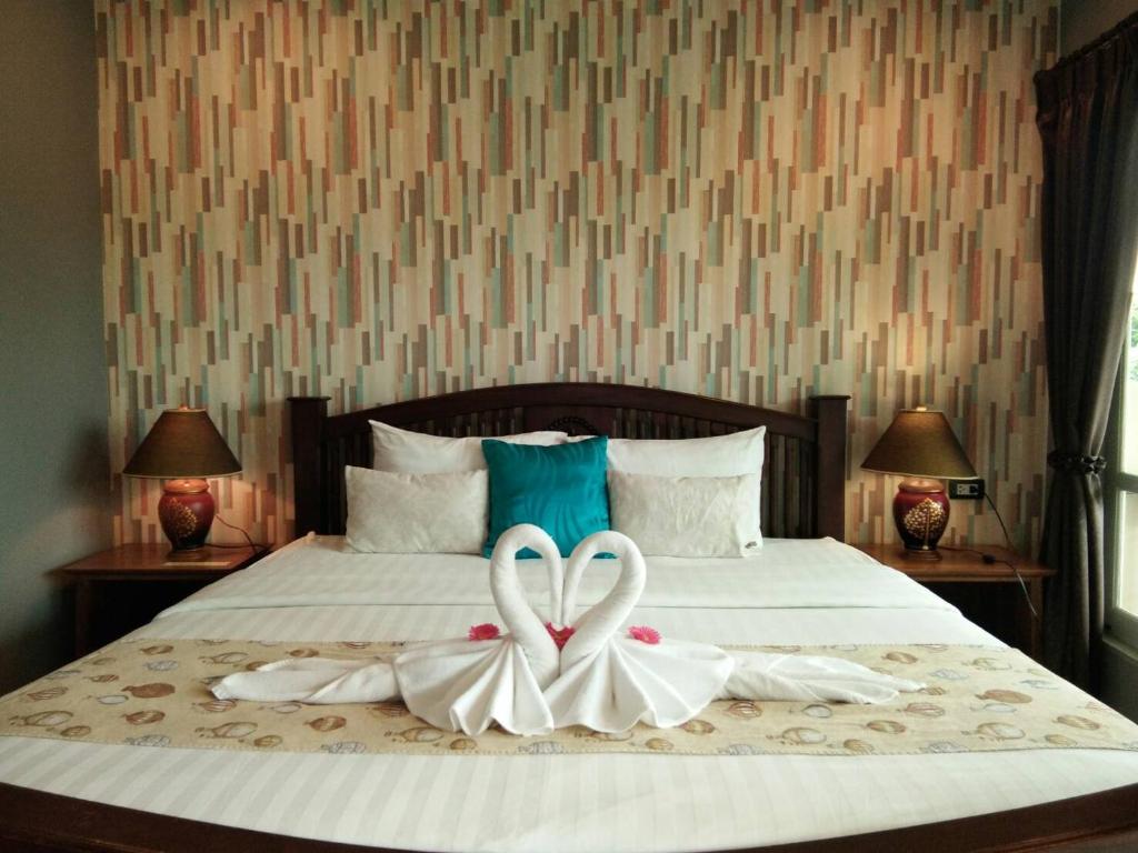 Postel nebo postele na pokoji v ubytování Scent of Sukhothai Resort