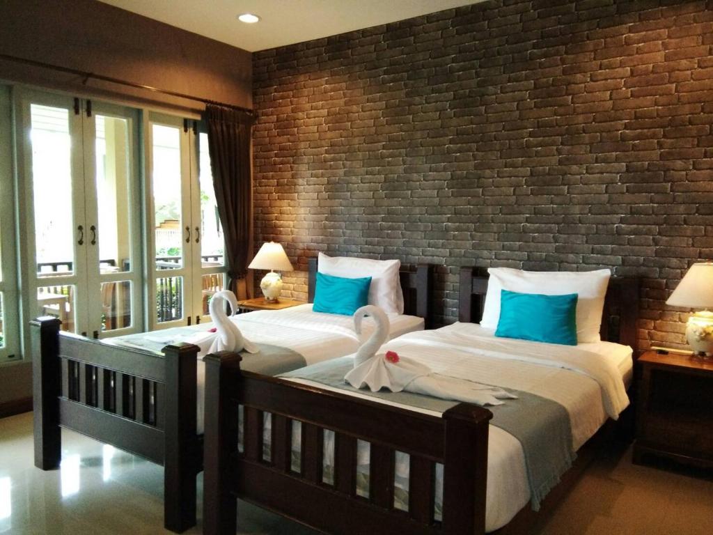 Postel nebo postele na pokoji v ubytování Scent of Sukhothai Resort