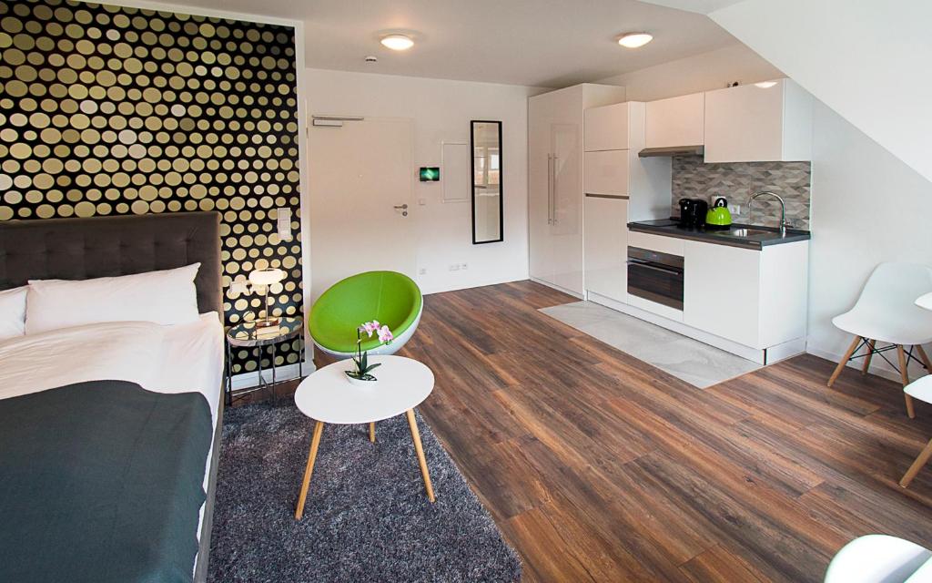 a living room with a bed and a kitchen at Eco Smart Apartments Nürnberg Süd in Nuremberg