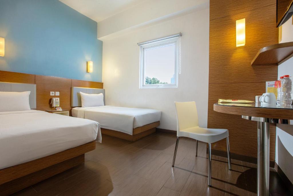 Säng eller sängar i ett rum på Amaris Hotel Pancoran