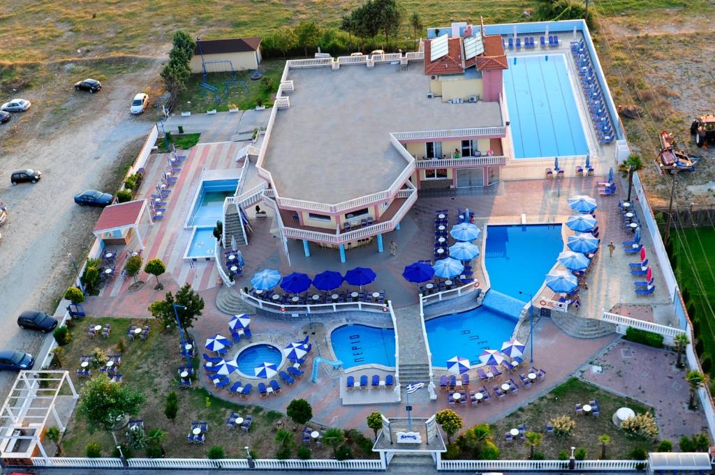 an overhead view of a pool with tables and umbrellas at Hotel Aperio in Paralia Katerinis