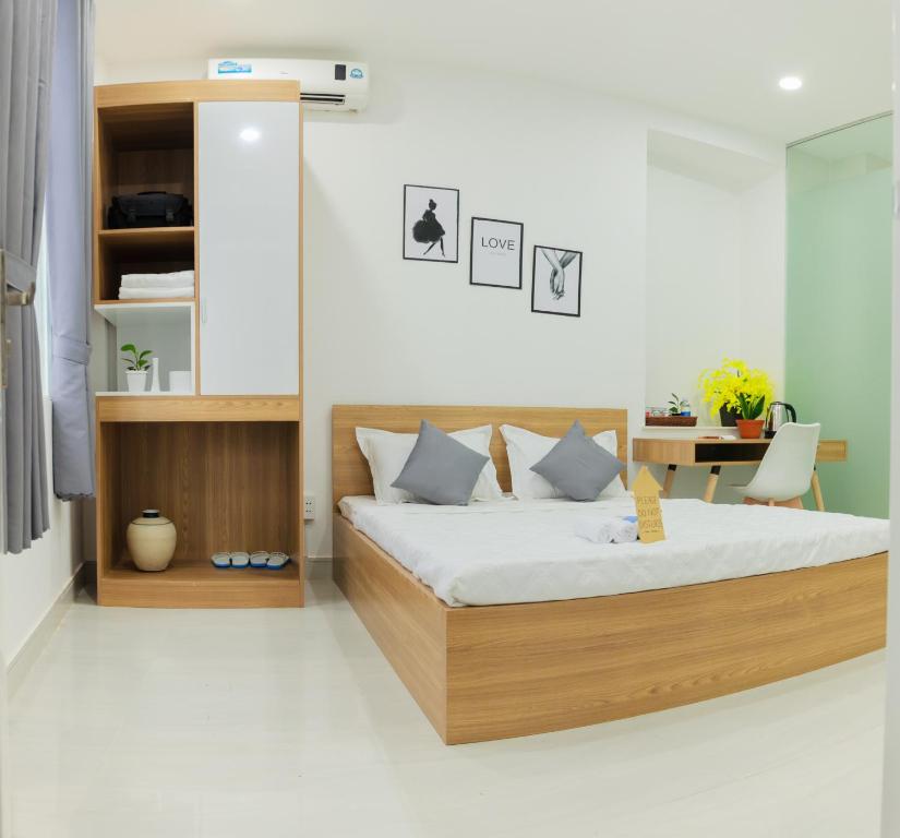 a bedroom with a bed and a desk at Hello SaiGon Homestay in Ho Chi Minh City