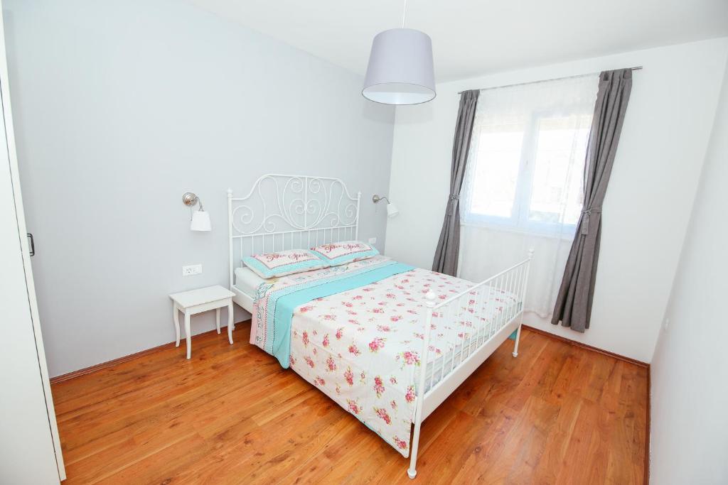 Posteľ alebo postele v izbe v ubytovaní Apartmani Maksan