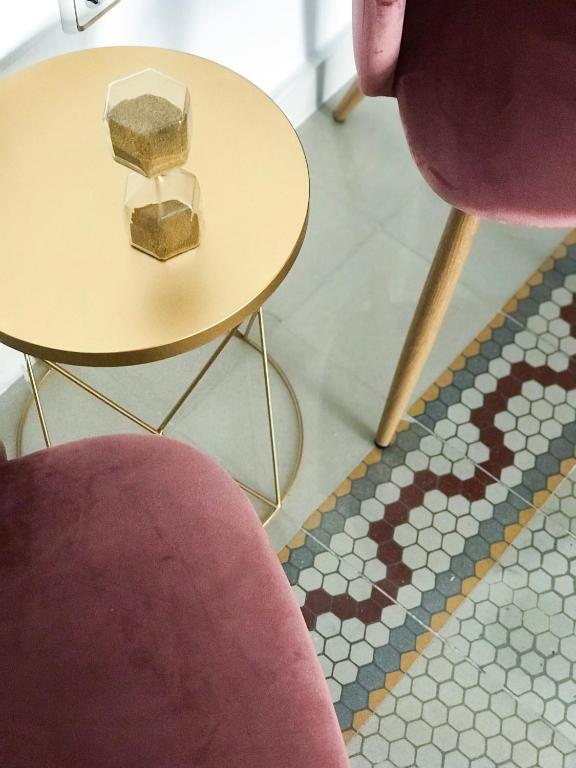 a table and a chair next to two tables and a rug at ROOMQUEO-Only Adults in Barbate