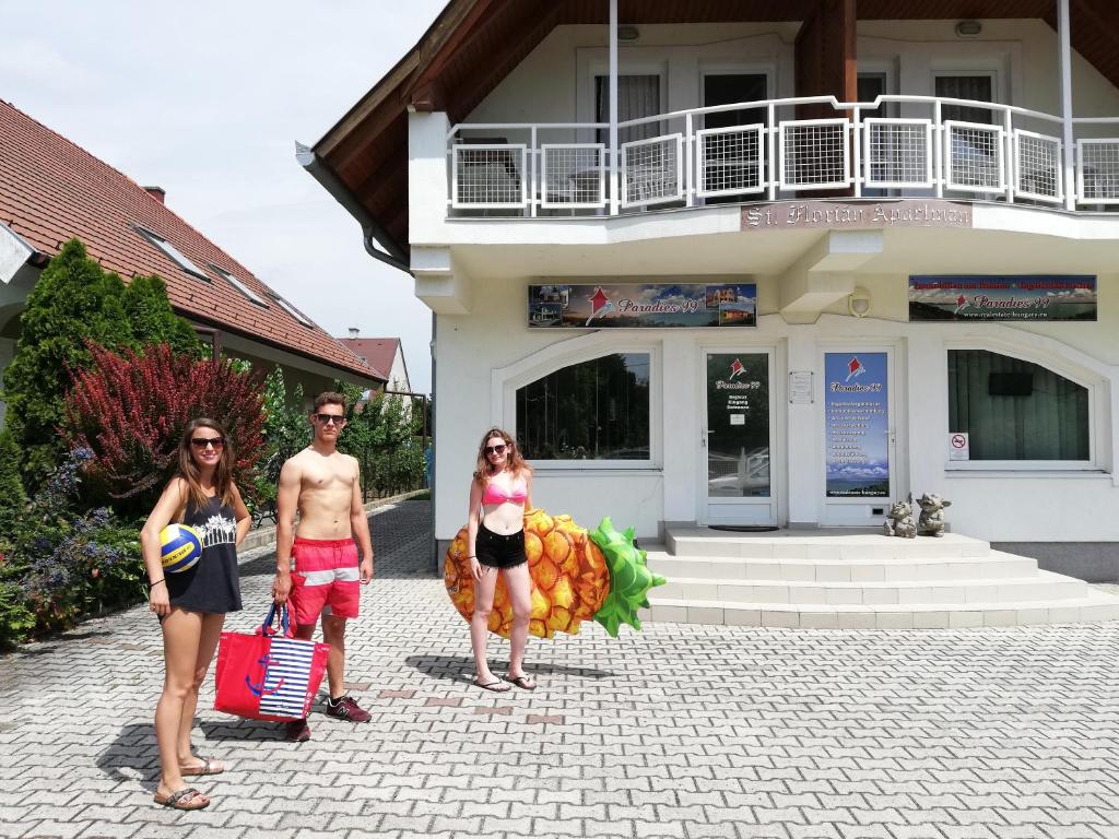 a group of people standing in front of a building at St.Flórián Apartman in Keszthely