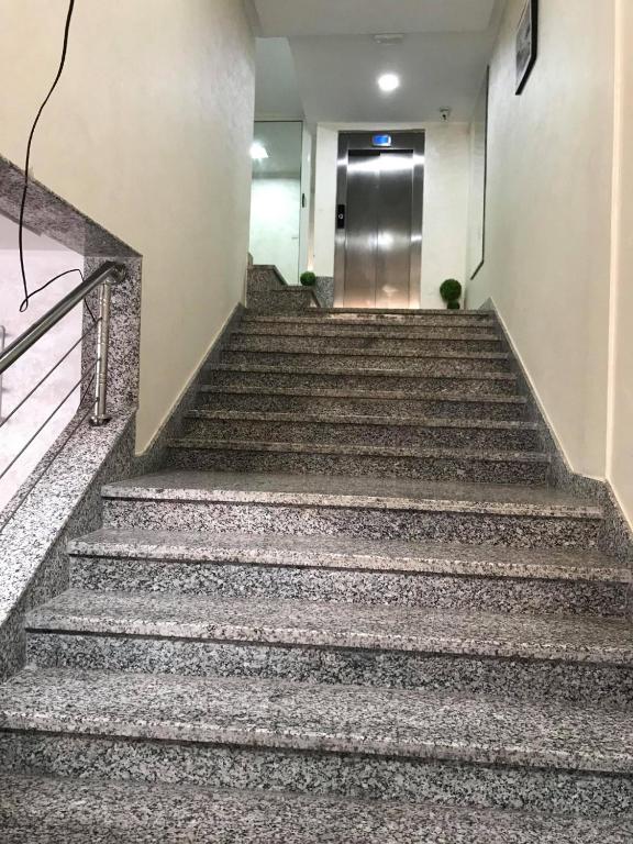 a set of stairs in a building with a elevator at HOTEL BORJ EL ARAB in Khouribga