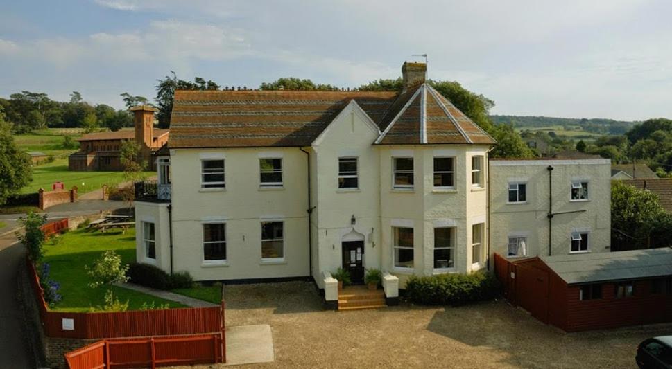 a large white house with a fence in front of it at YHA Isle of Wight Totland - Partner in Totland