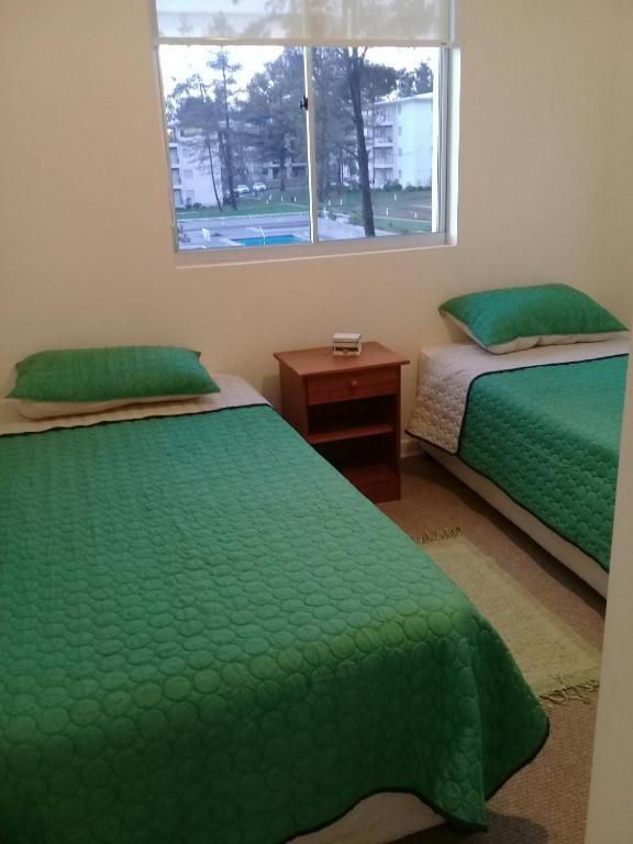Postel nebo postele na pokoji v ubytování Esmeralda Apartment