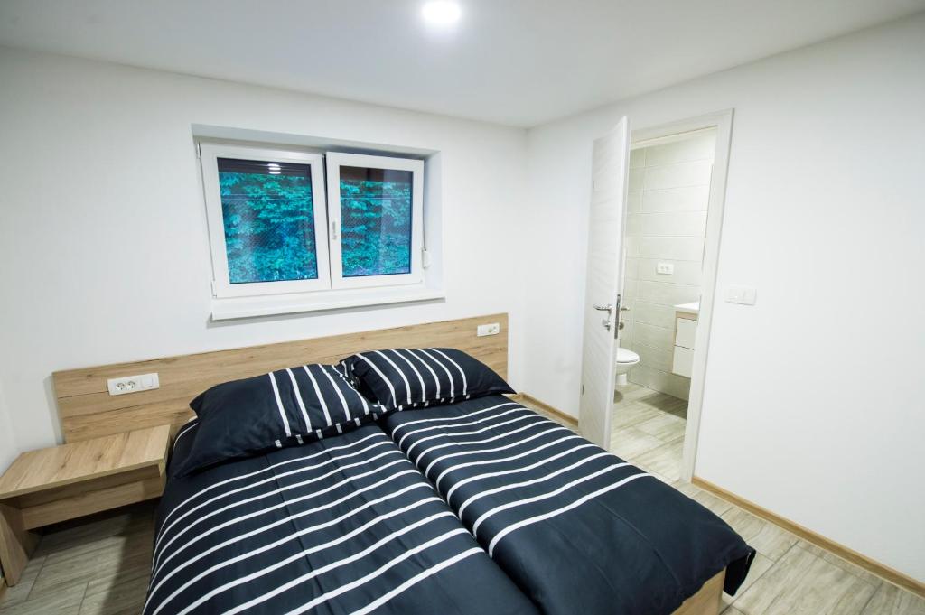 Postel nebo postele na pokoji v ubytování Guesthouse Urša