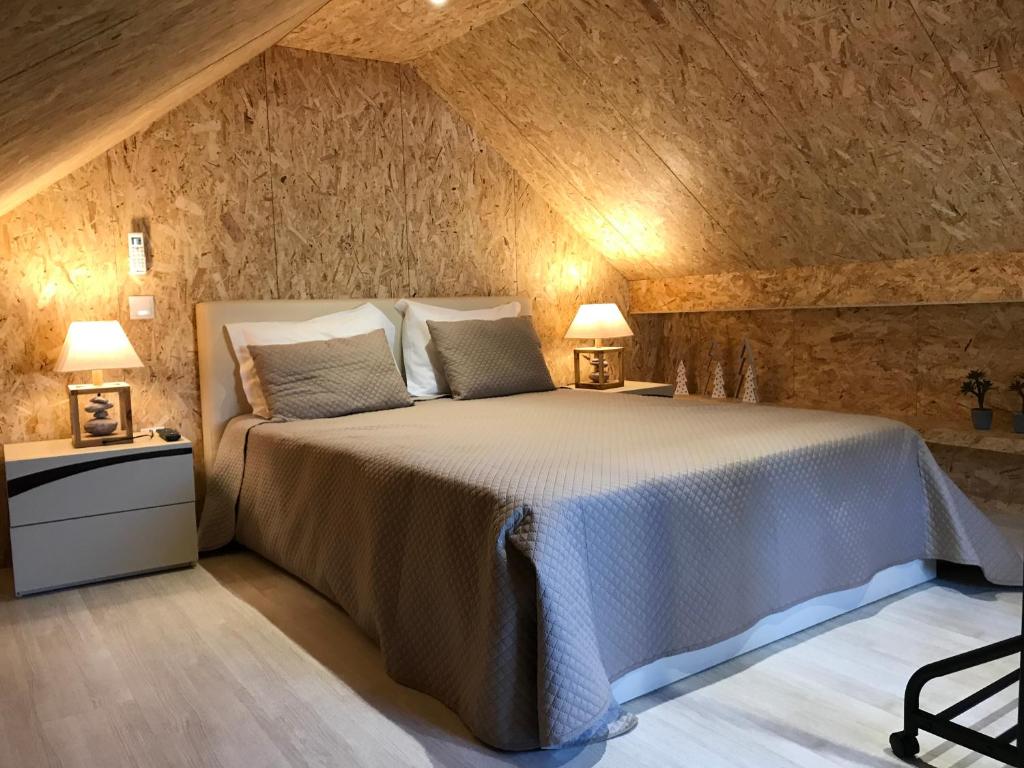 a bedroom with a bed and two lamps on tables at House 41 in Vila Nova de Famalicão