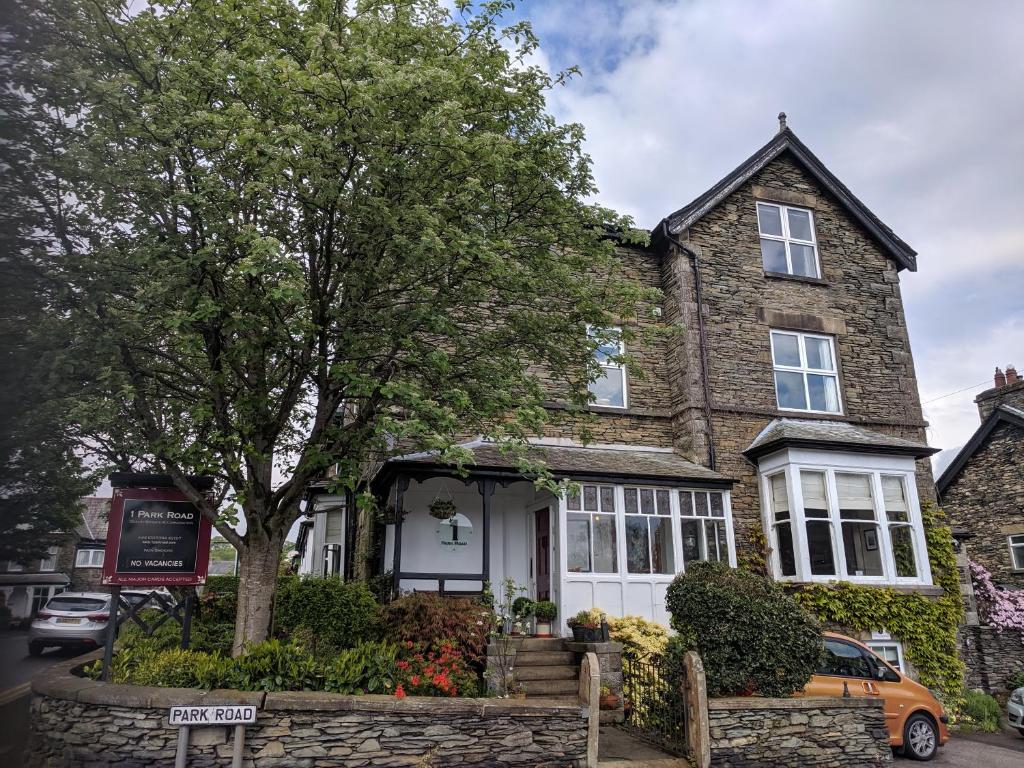 una casa con un árbol delante de ella en 1 Park Road en Windermere