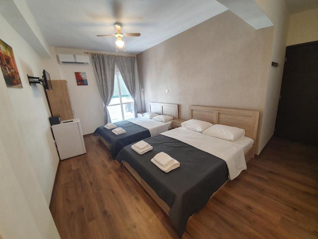 a bedroom with two beds and a window at City Centre Stylish rooms in Athens