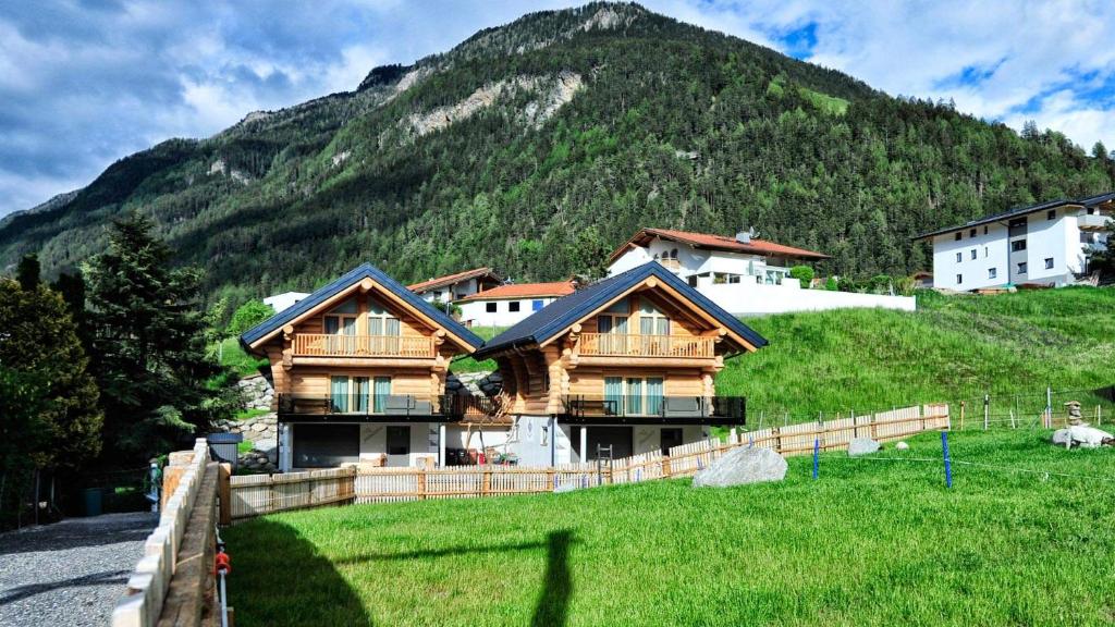 a house on a hill in front of a mountain at Summit Lodges in Pfunds