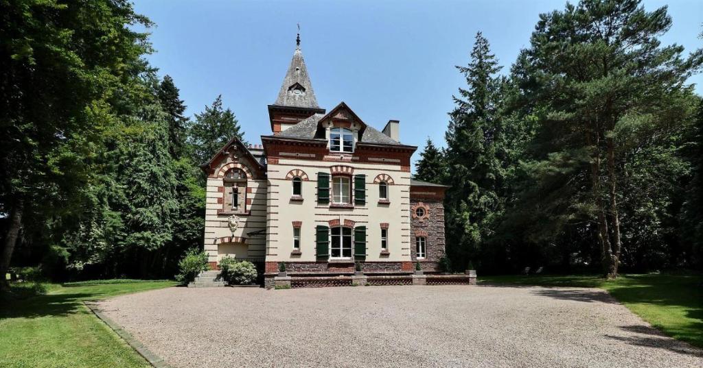 an old house with a tower on top of it at Manoir Les Brieux in Plélan-le-Grand