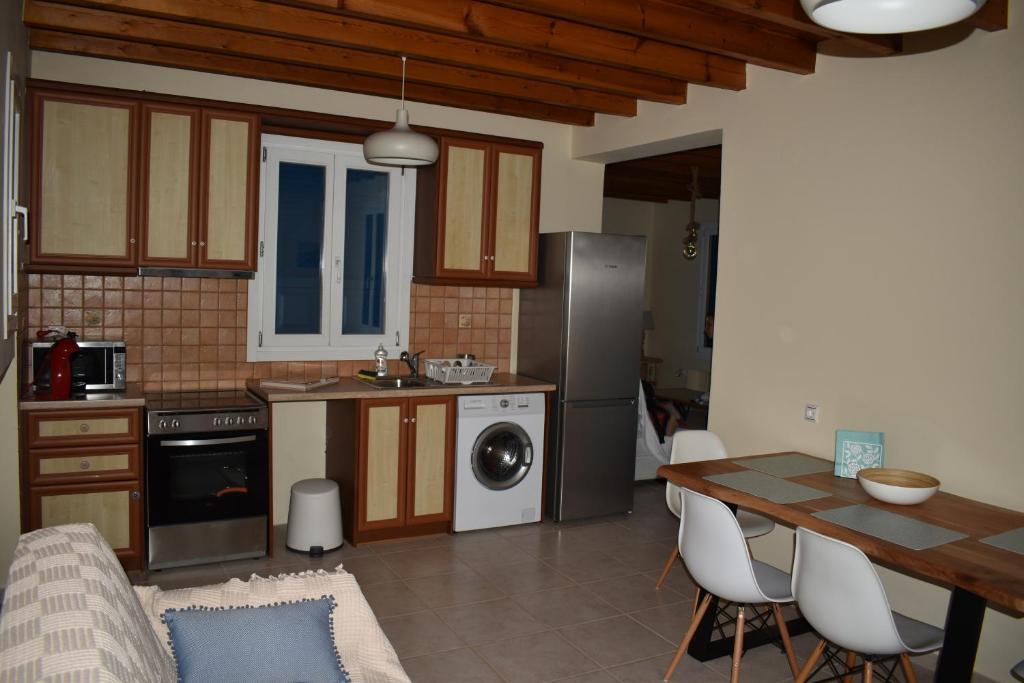 a kitchen with a table and a dining room at Monolithos Villas in Kipri