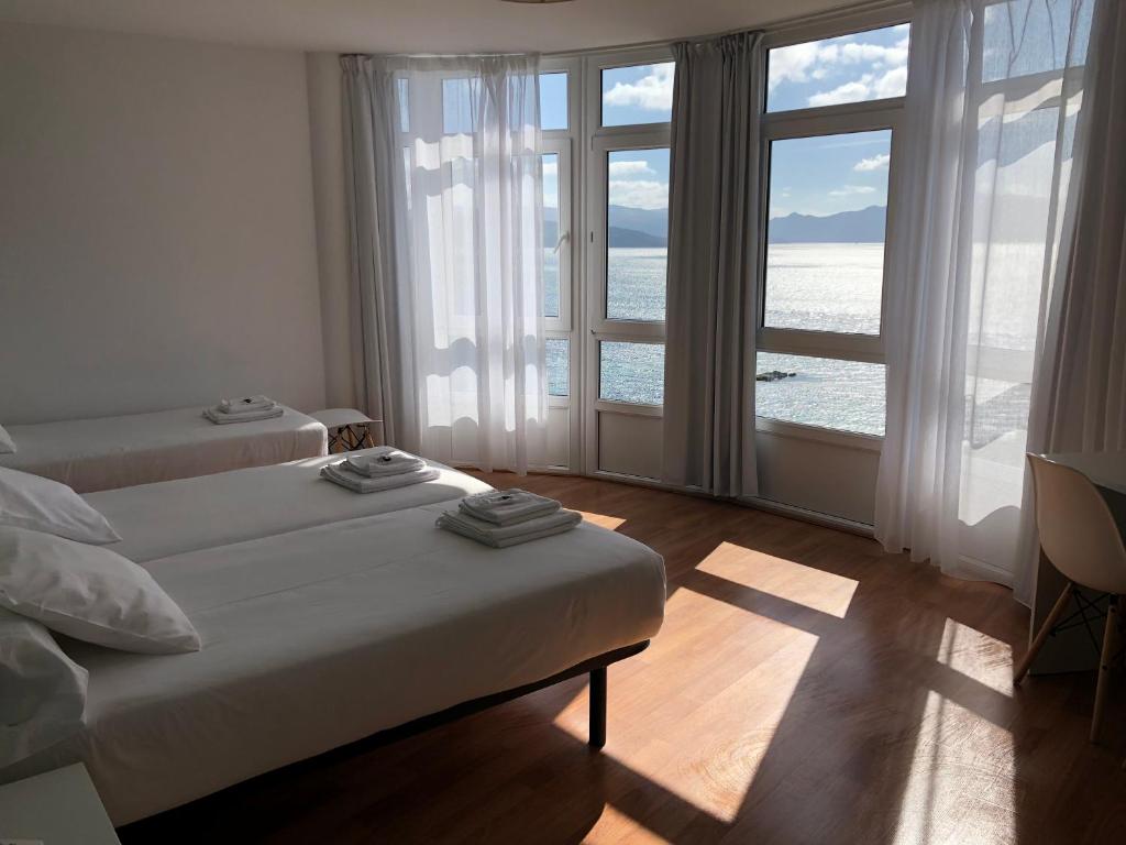 Cama o camas de una habitación en Hotel Mar de Fisterra