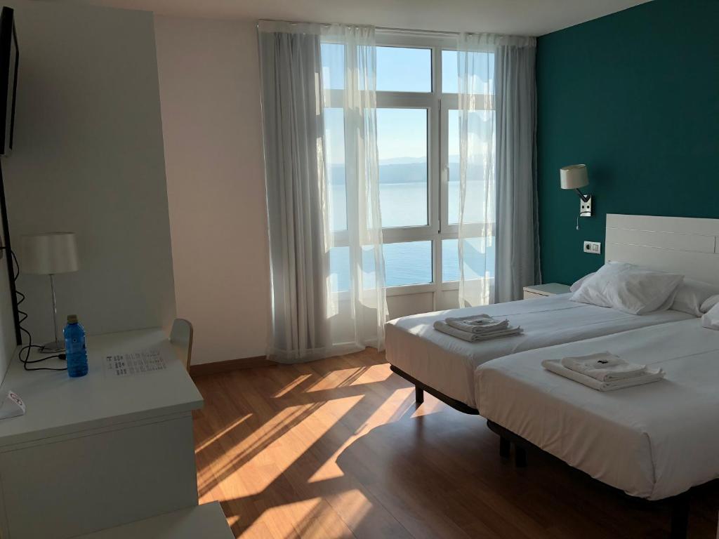 Cama o camas de una habitación en Hotel Mar de Fisterra